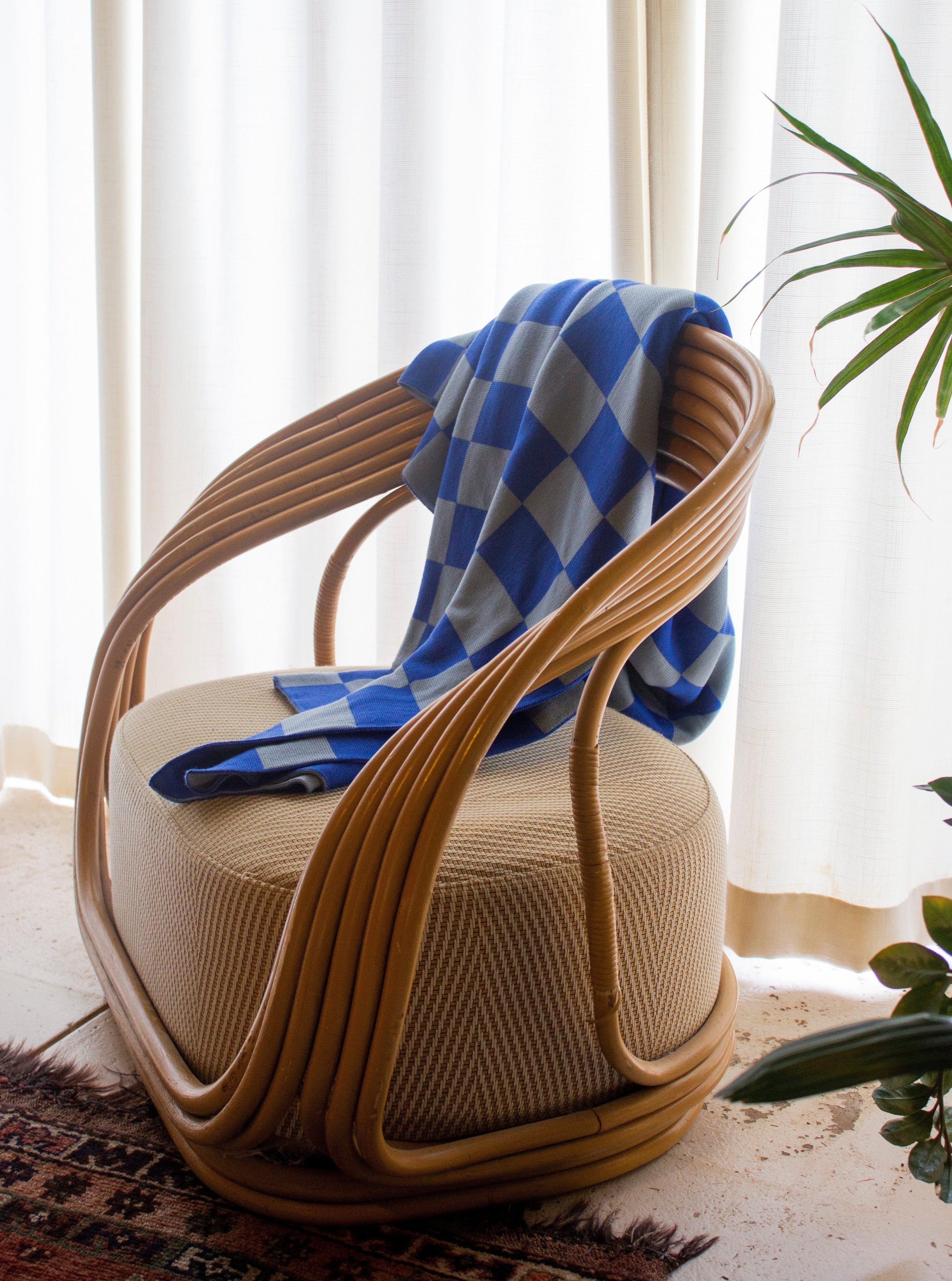 A blue Check merino wool blanket. Bright and rich in colour and handfeel. The blanket is 2kg of the finest Australian Merino wool. sizes baby, queen and king.