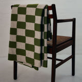 Green and Wheat Checkered pattern merino wool blanket. The Blanket is knitted in Melbourne by a skilled team of makers. The blankets use 2kgs of merino wool making them heavy and lush, unlike anything else.