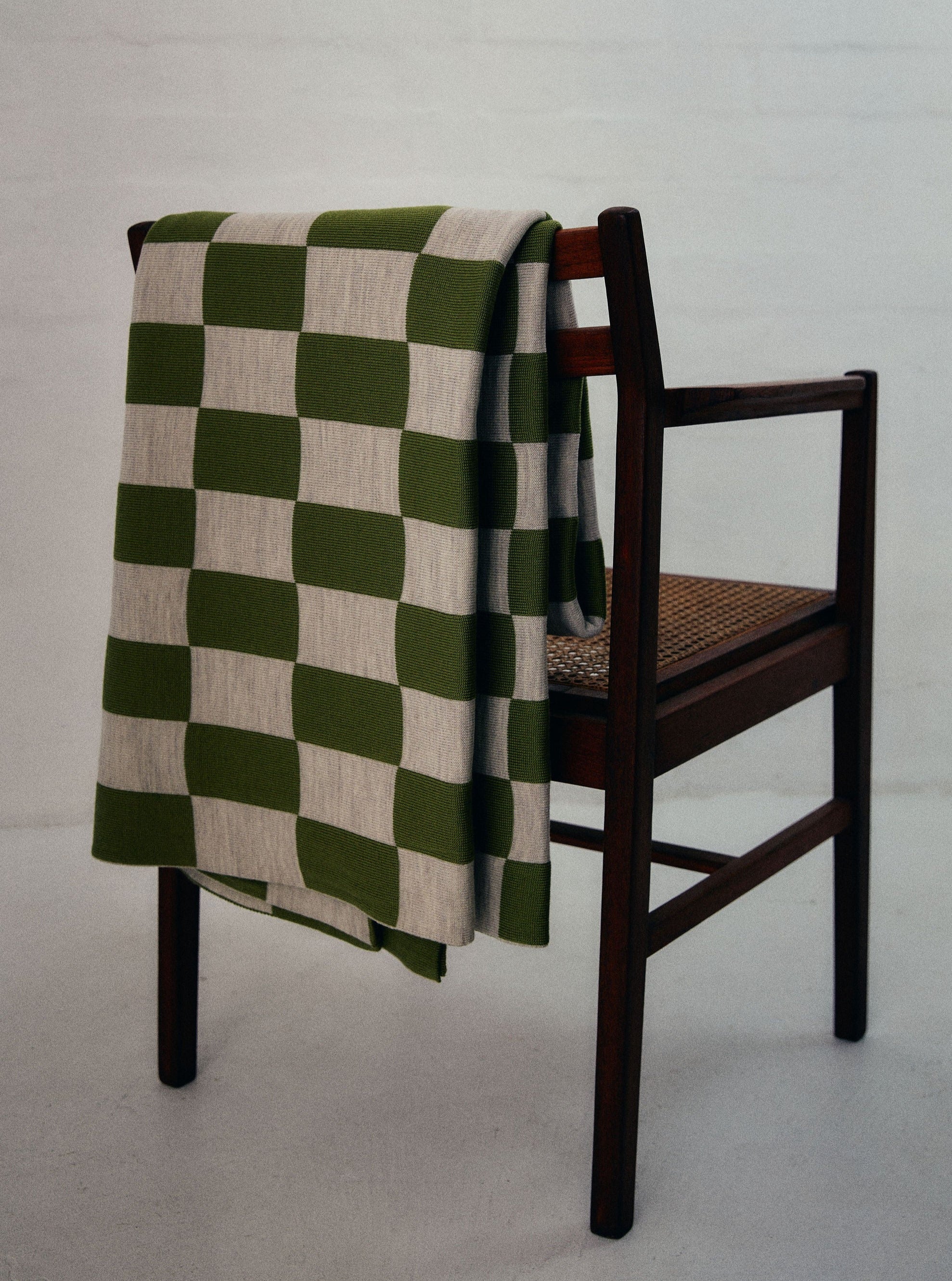 Green and Wheat Checkered pattern merino wool blanket. The Blanket is knitted in Melbourne by a skilled team of makers. The blankets use 2kgs of merino wool making them heavy and lush, unlike anything else.