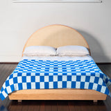 A blue Check merino wool blanket. Bright and rich in colour and handfeel. The blanket is 2kg of the finest Australian Merino wool. sizes baby, queen and king.