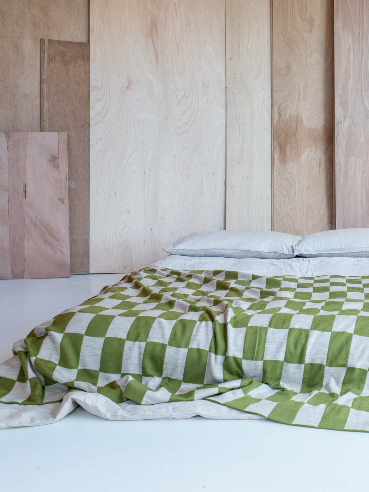 Green and Wheat Checkered pattern merino wool blanket. The Blanket is knitted in Melbourne by a skilled team of makers. The blankets use 2kgs of merino wool making them heavy and lush, unlike anything else.
