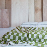 Green and Wheat Checkered pattern merino wool blanket. The Blanket is knitted in Melbourne by a skilled team of makers. The blankets use 2kgs of merino wool making them heavy and lush, unlike anything else.