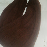 Brown knitted scarf with a label on a white background