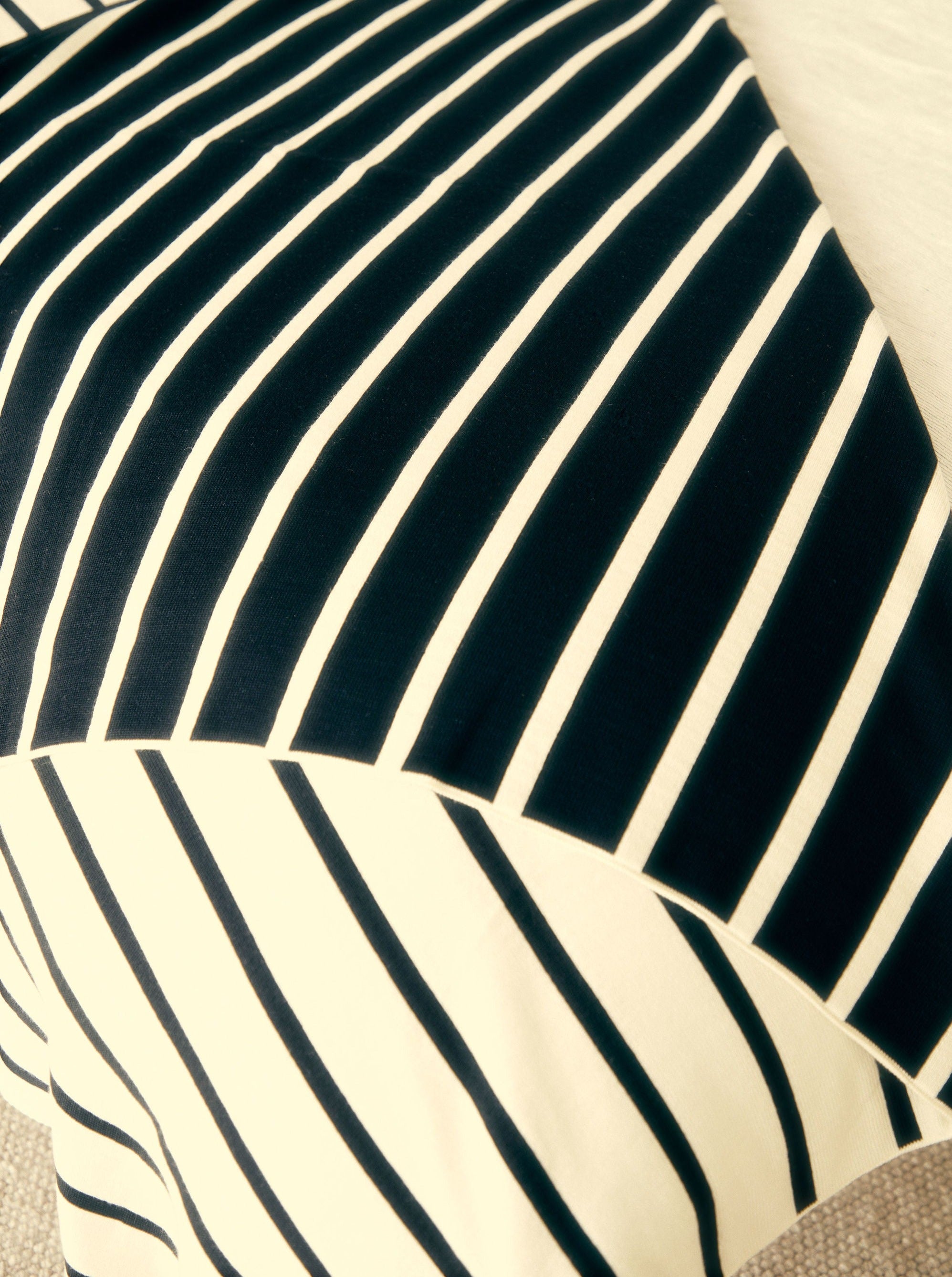 Black & White Life in Stripes merino throw on bed, Melbourne-made, 100% Australian fibre