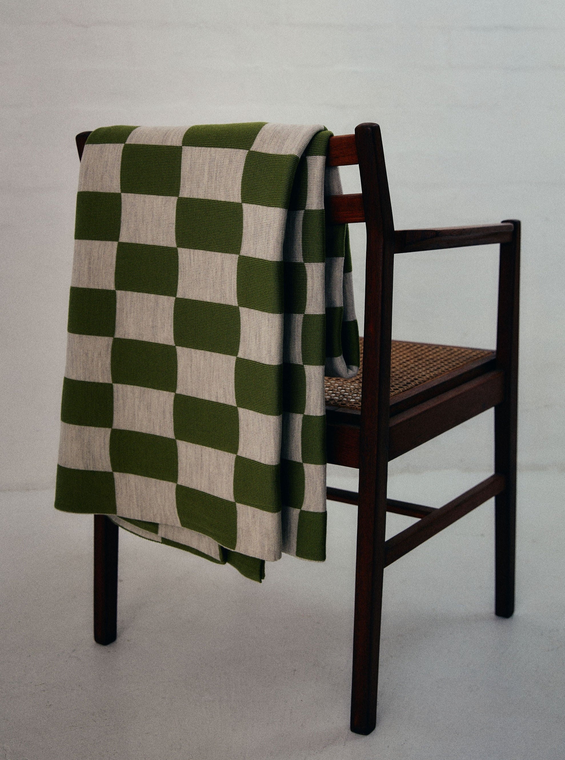 Green and Wheat Checkered pattern merino wool blanket. The Blanket is knitted in Melbourne by a skilled team of makers. The blankets use 2kgs of merino wool making them heavy and lush, unlike anything else. 