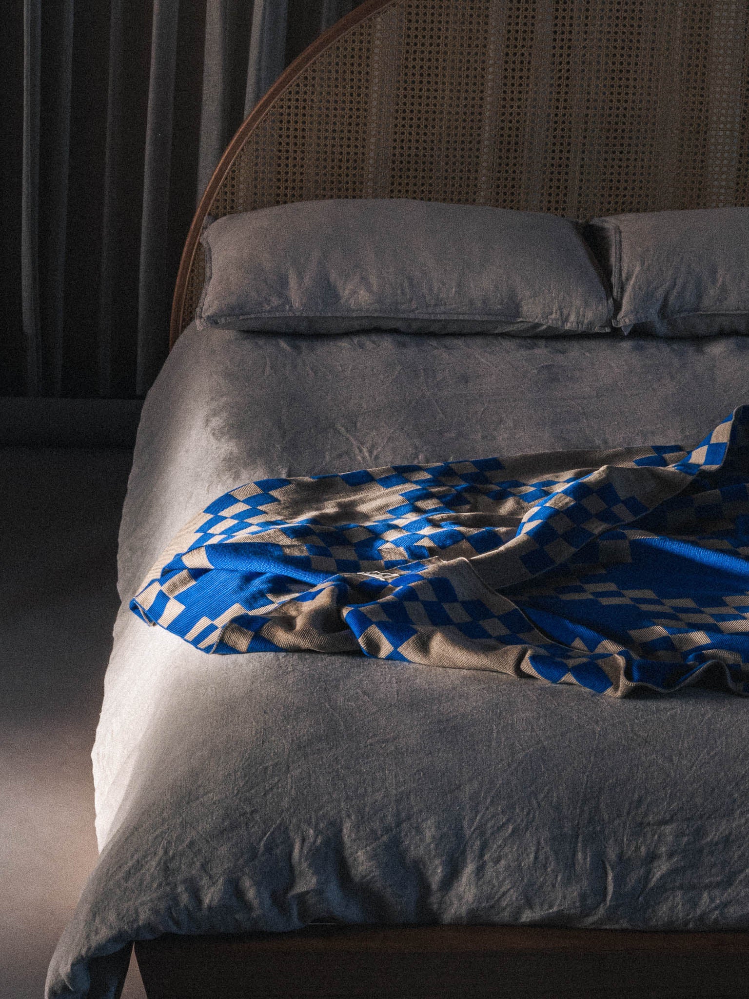 The WAVE blanket in CURIO’s signature balanced chain check is knitted from the finest Merino wool yarn (21 microns) for unparalleled softness and durability. Blanket edges are finished by hand, and the CURIO label affixed to each blanket is embroidered in Central Victoria from Australian cotton and attached by hand.. The blanket is Bright blue with checked pattern throughout and a mushroom base colour